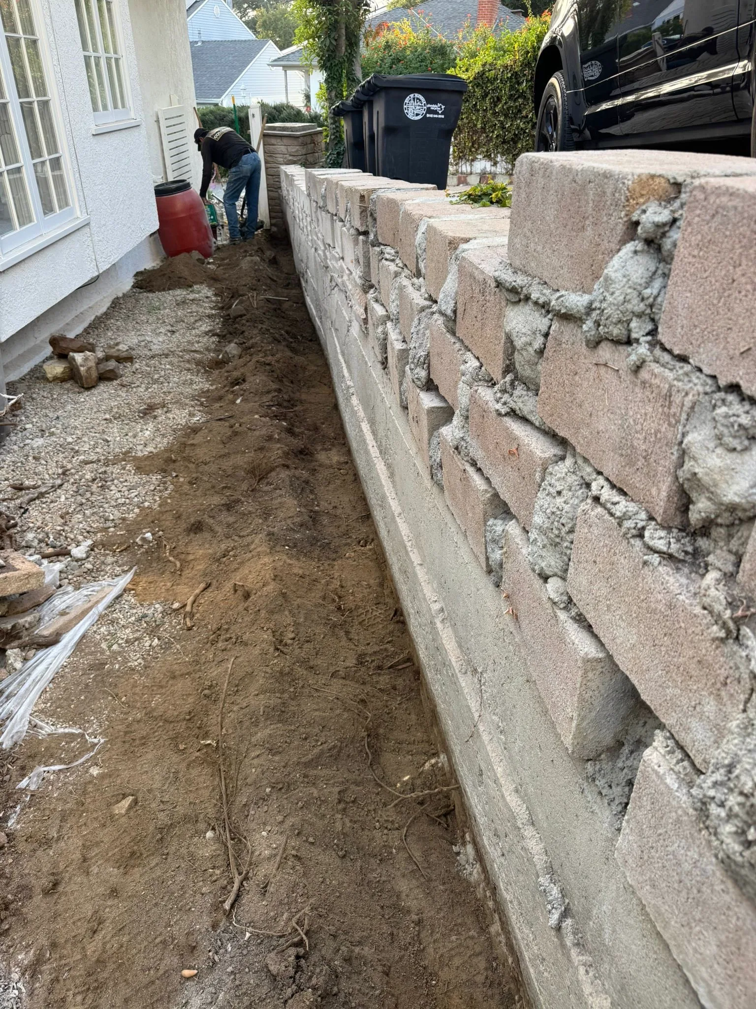 Block wall mid-build with fresh mortar joints