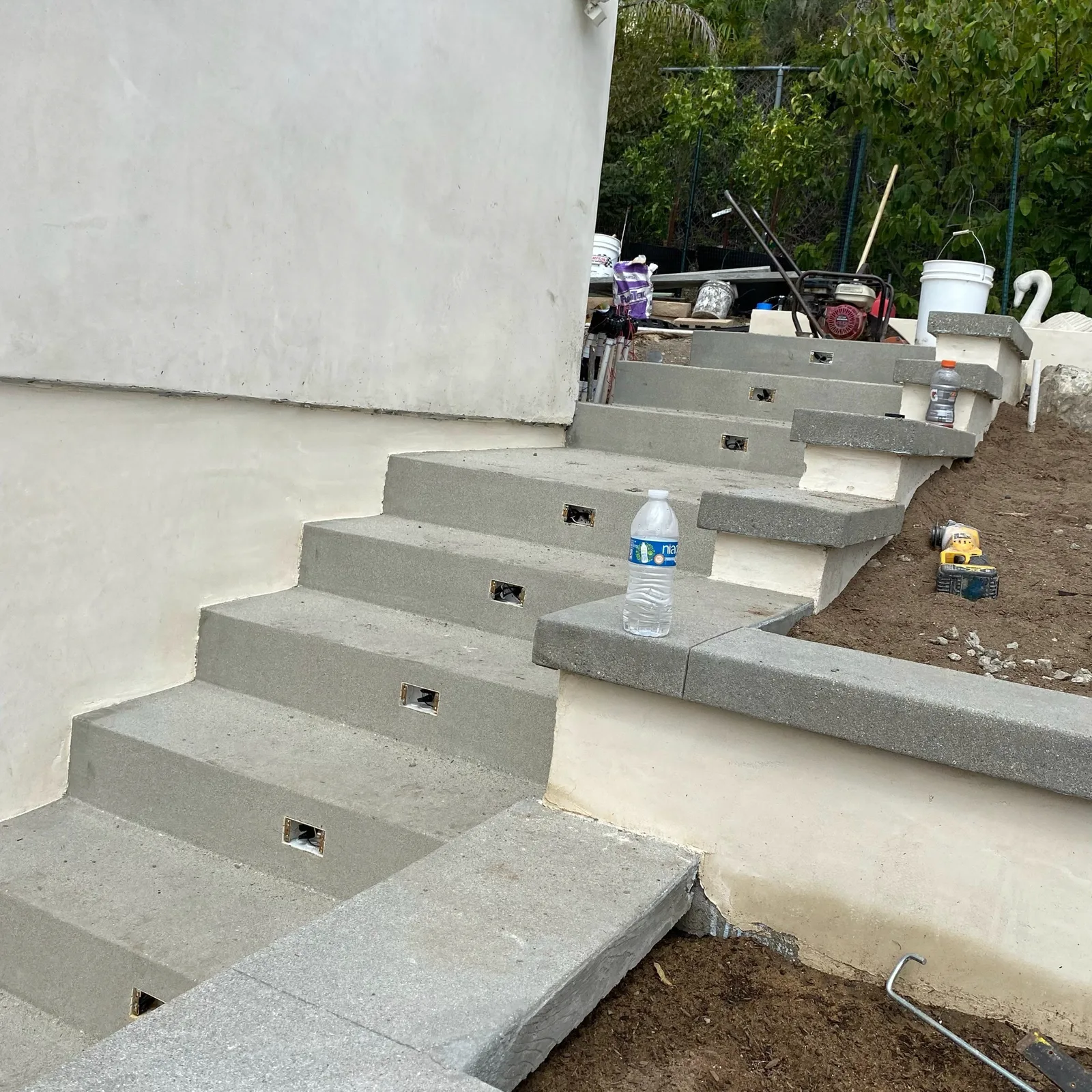New concrete steps with built-in lighting on a slope
