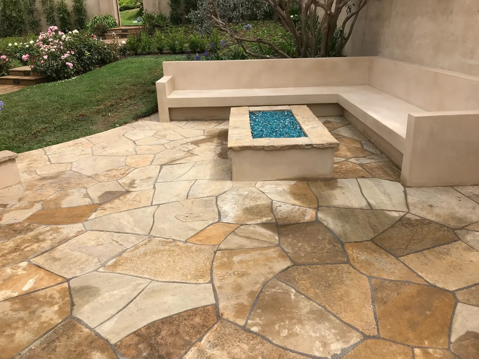 Flagstone patio with fire pit and stucco seating bench