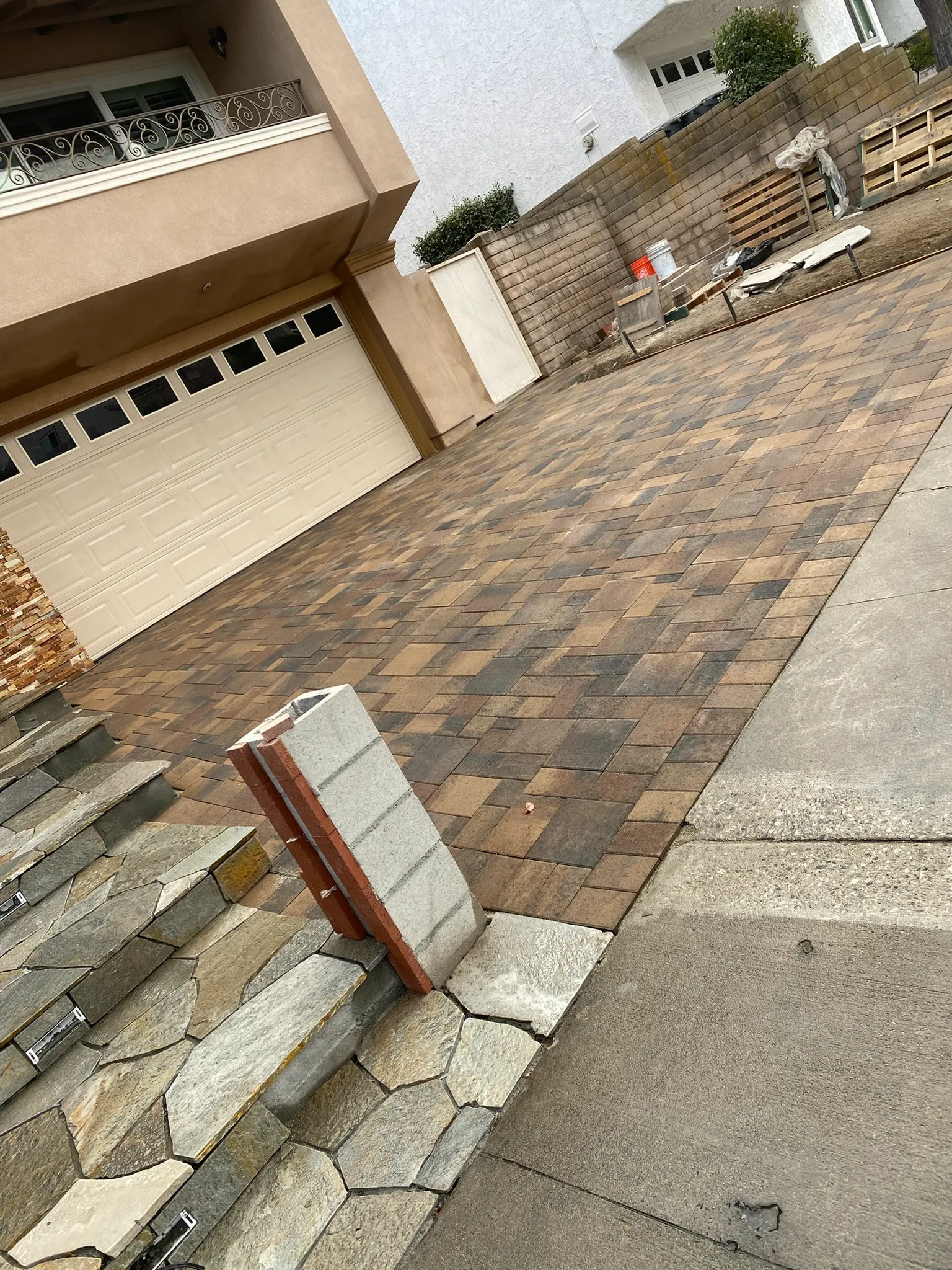 Interlocking paver driveway leading to a garage